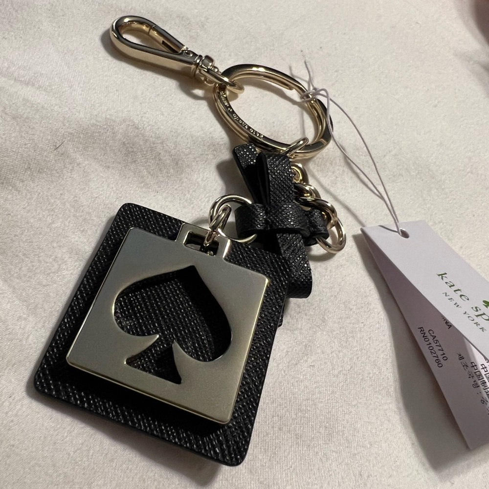 Black and gold cut out Kate Spade key fob / bag charm